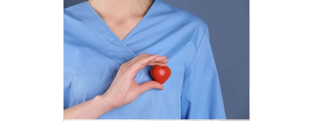 medico che regge in mano un cuore finto al posto del cuore